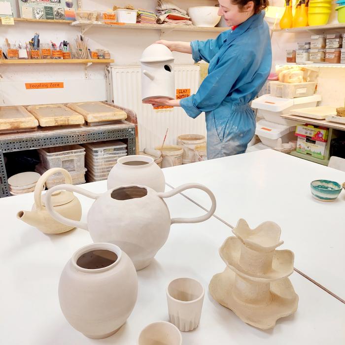 Firing of clay work into ceramic ware